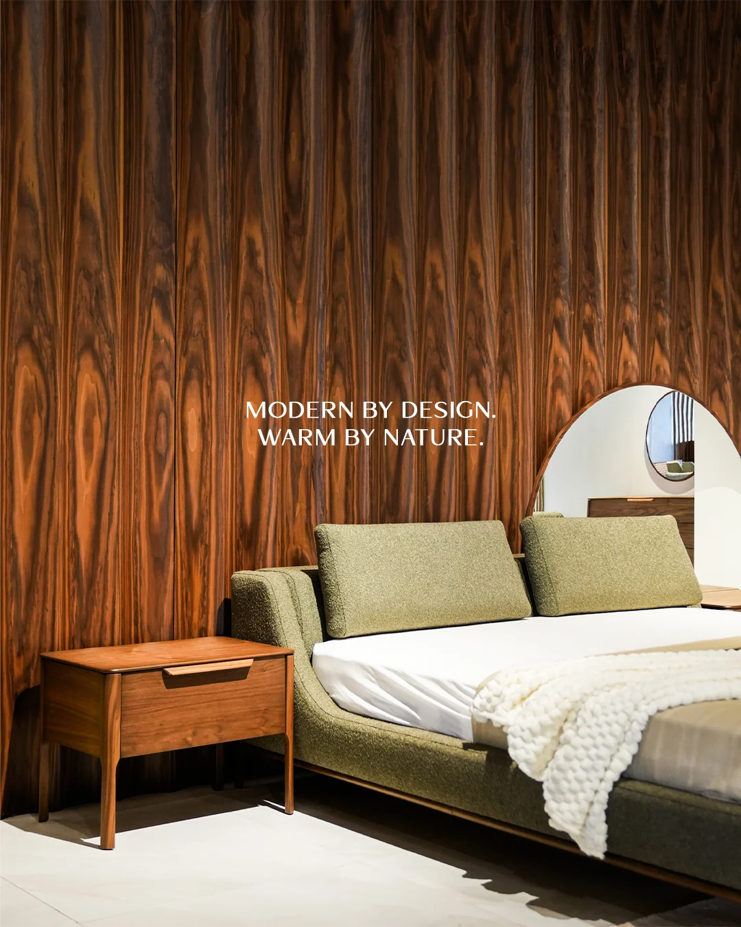 Upholstered bed against a warm wood feature wall