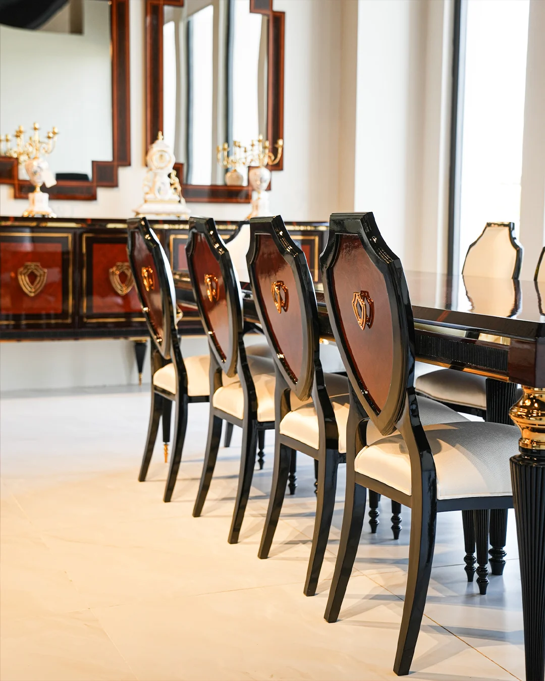 Classic dining table and upholstered chairs with decorative detailing