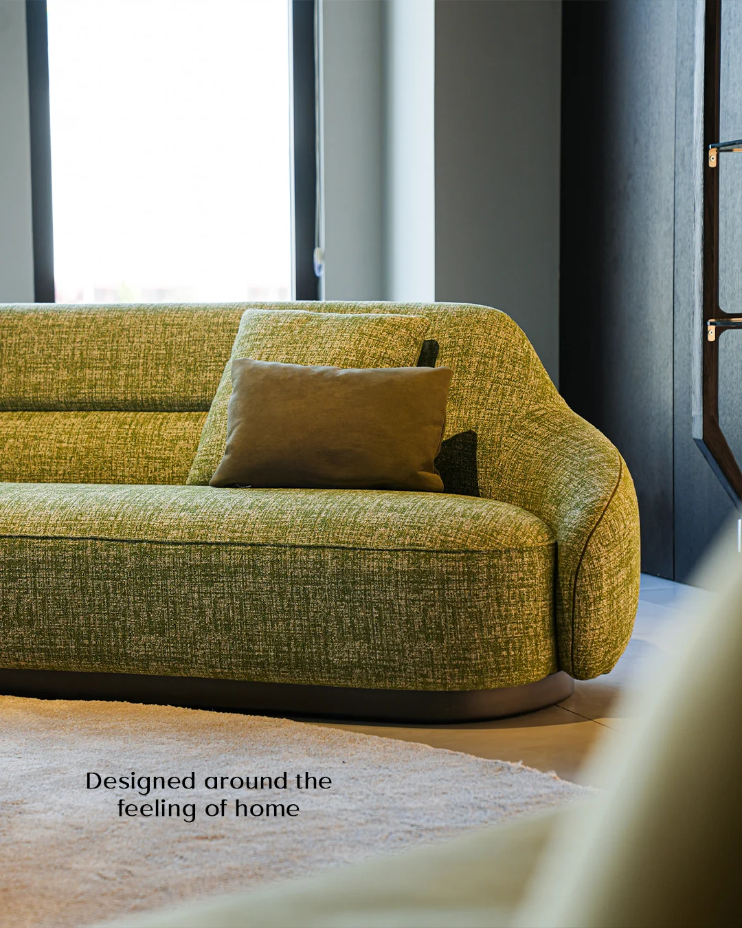 Sculptural green sofa in a warm, contemporary interior
